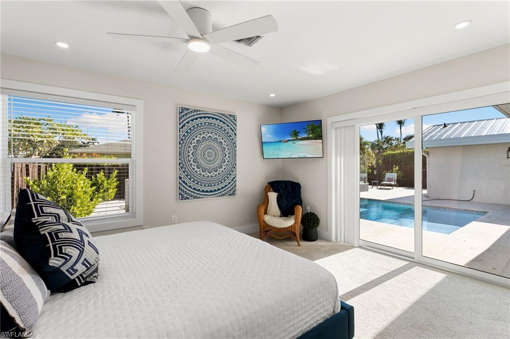 321 Columbus Way Marco Island, FL 34145 - Photo 14 of 40 Carpeted bedroom featuring access to exterior, ceiling fan, and a sunroom