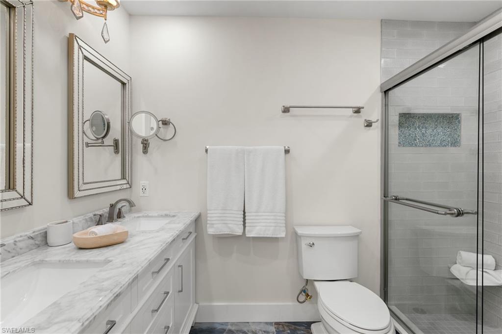 321 Columbus Way Marco Island, FL 34145 - Photo 15 of 40 Bathroom with double vanity and a shower stall