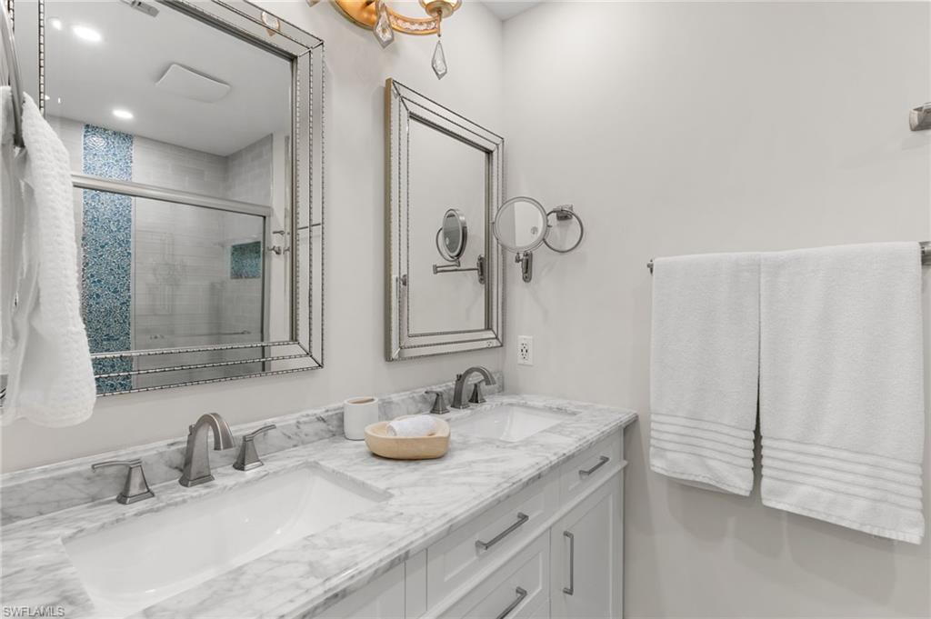 321 Columbus Way Marco Island, FL 34145 - Photo 16 of 40 Full bath featuring a stall shower and double vanity