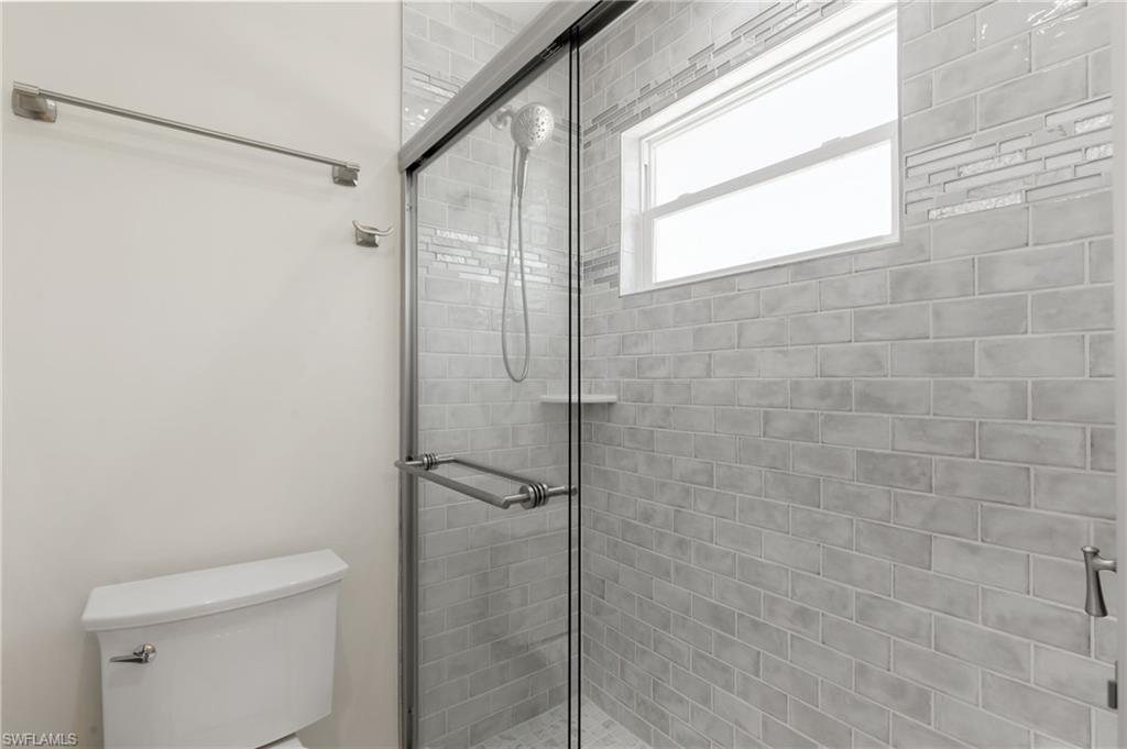 321 Columbus Way Marco Island, FL 34145 - Photo 20 of 40 Full bathroom featuring a stall shower and toilet