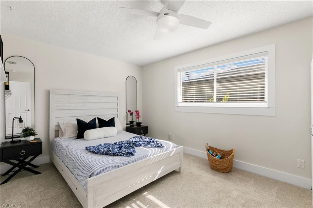 321 Columbus Way Marco Island, FL 34145 - Photo 21 of 40 Bedroom with a textured ceiling, ceiling fan, and light colored carpet