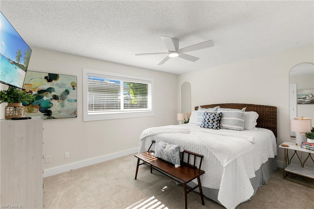 321 Columbus Way Marco Island, FL 34145 - Photo 22 of 40 Bedroom featuring carpet floors, a textured ceiling, and ceiling fan