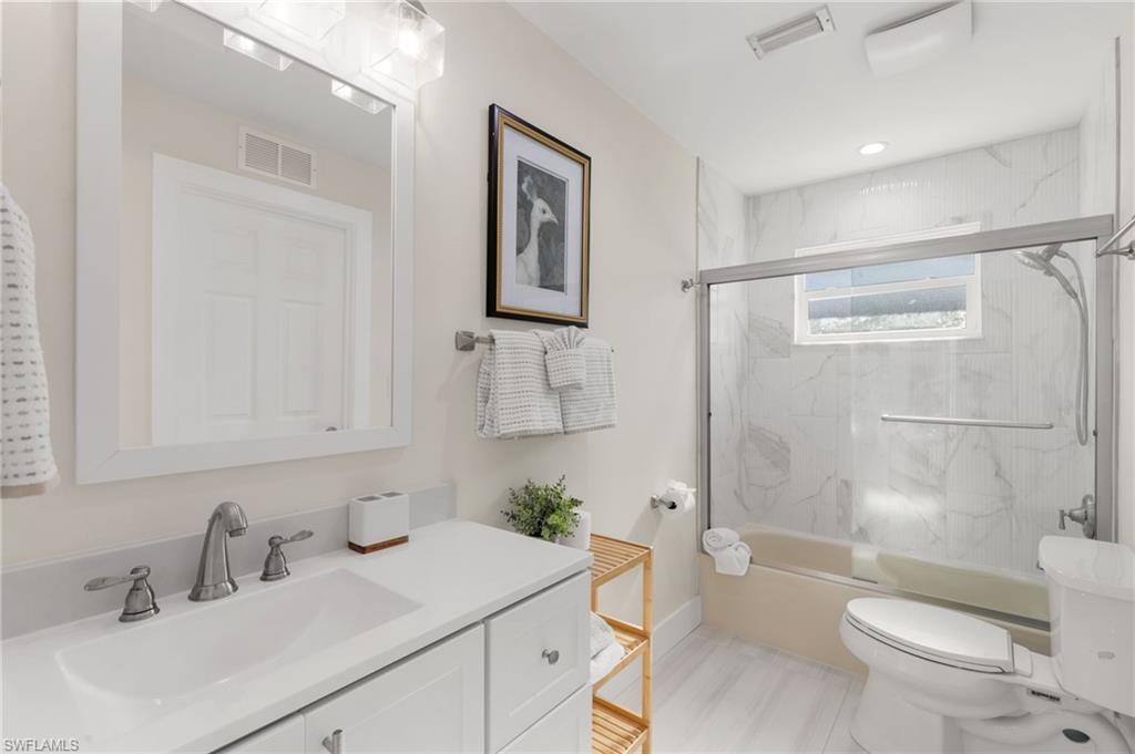 321 Columbus Way Marco Island, FL 34145 - Photo 23 of 40 Full bath with vanity and shower / bath combination with glass door