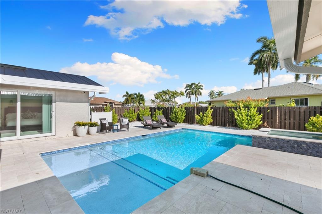 321 Columbus Way Marco Island, FL 34145 - Photo 25 of 40 View of pool with a patio, a fenced backyard, and a pool with connected hot tub