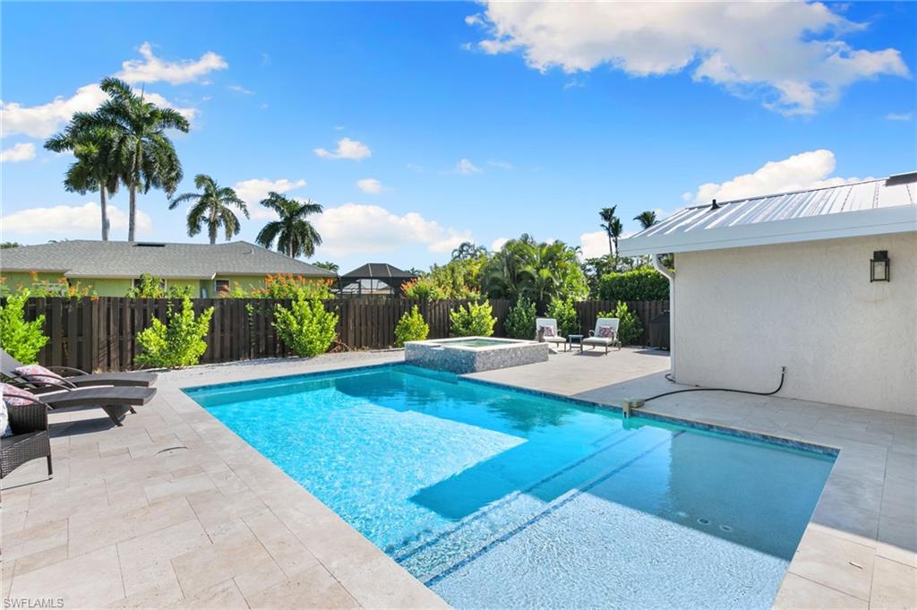 321 Columbus Way Marco Island, FL 34145 - Photo 26 of 40 View of pool with a patio, a fenced backyard, and a pool with connected hot tub