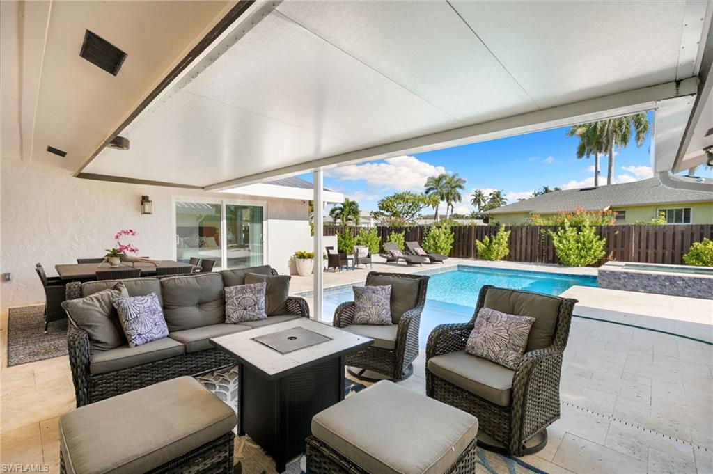 321 Columbus Way Marco Island, FL 34145 - Photo 28 of 40 Fenced backyard featuring a patio area, an outdoor living space, and a pool with connected hot tub
