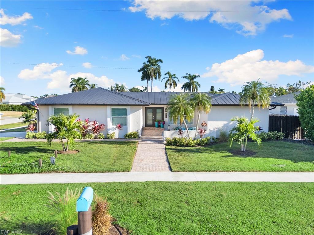 321 Columbus Way Marco Island, FL 34145 - Photo 31 of 40 Ranch-style home with a metal roof and stucco siding