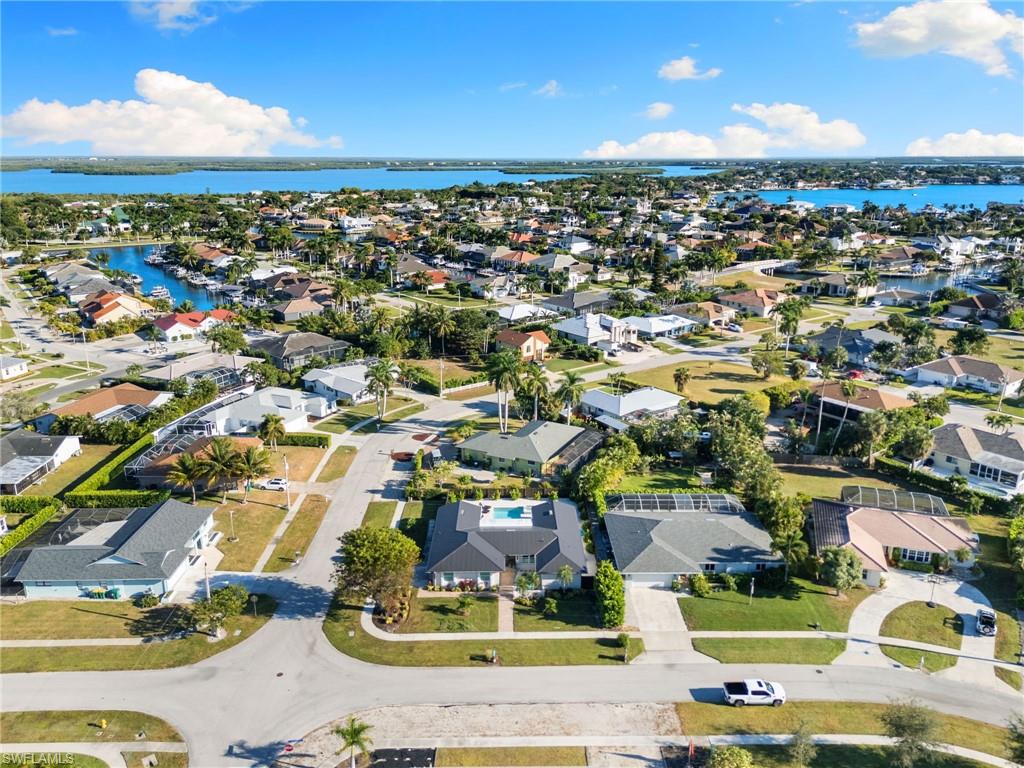 321 Columbus Way Marco Island, FL 34145 - Photo 35 of 40 Aerial view of property and surrounding area with nearby suburban area and a large body of water