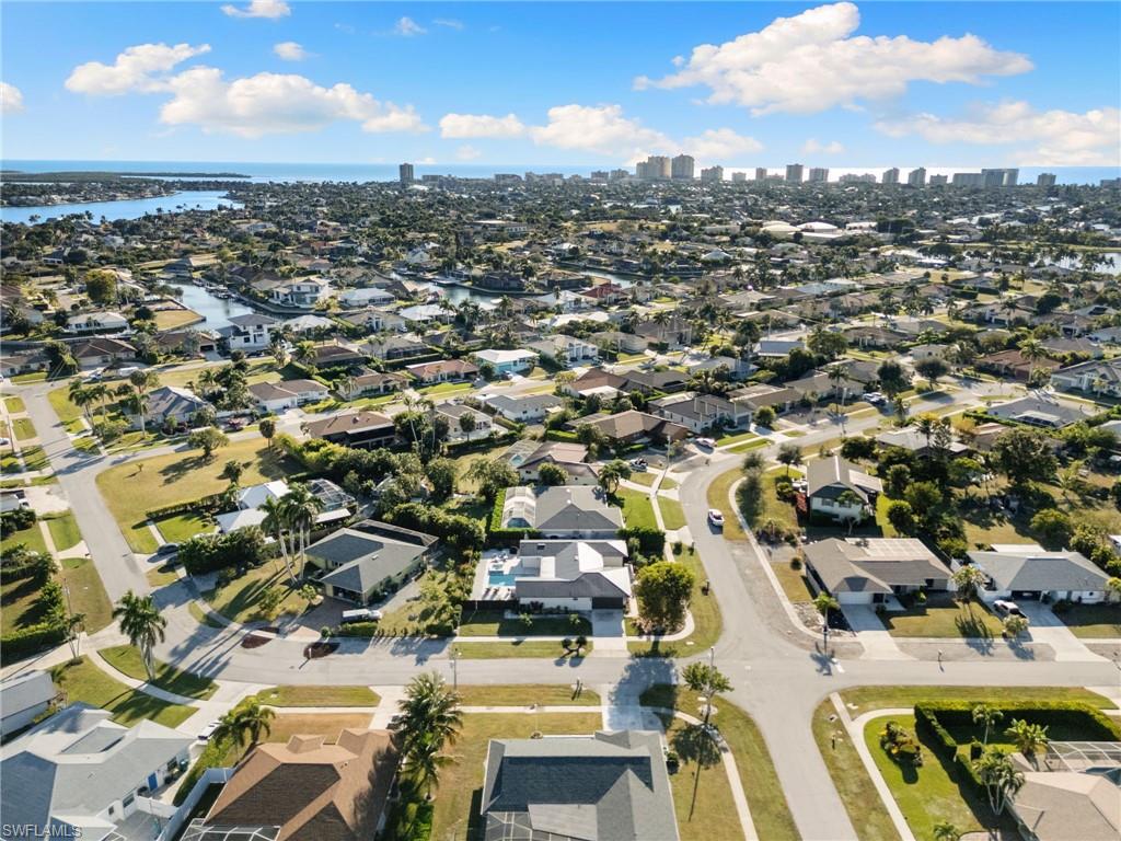 321 Columbus Way Marco Island, FL 34145 - Photo 36 of 40 Aerial view of property and surrounding area featuring a nearby body of water and nearby suburban area