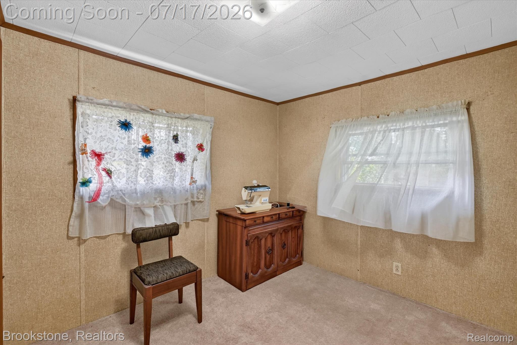 22025 Lakefield Road Merrill, MI 48637 - Photo 30 of 47 Room featuring two windows, neutral carpet flooring, and paneled walls