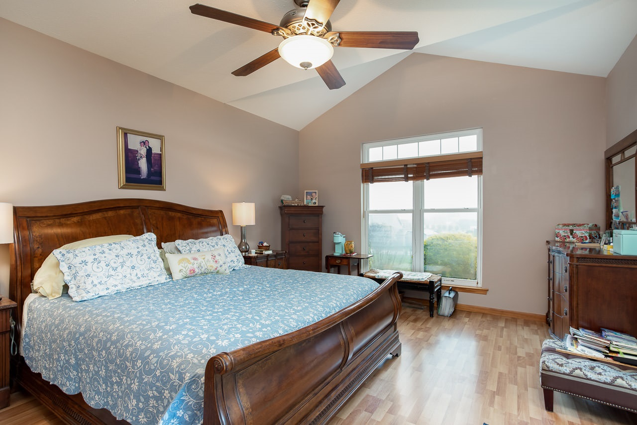 180 Ridgemore Drive Raphine, VA 24472 - Photo 21 of 68 a bedroom with a large bed and a chandelier