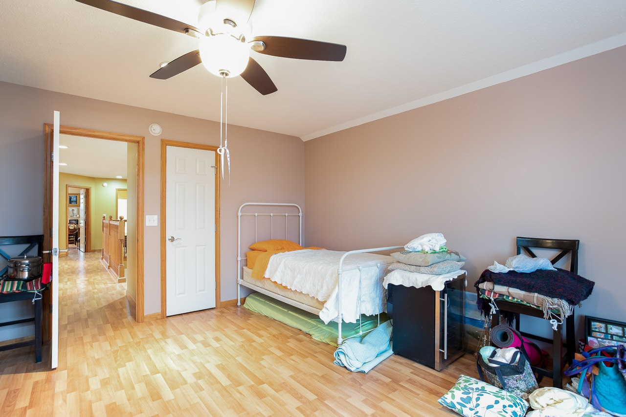 180 Ridgemore Drive Raphine, VA 24472 - Photo 32 of 68 a bedroom with a bed and a chandelier