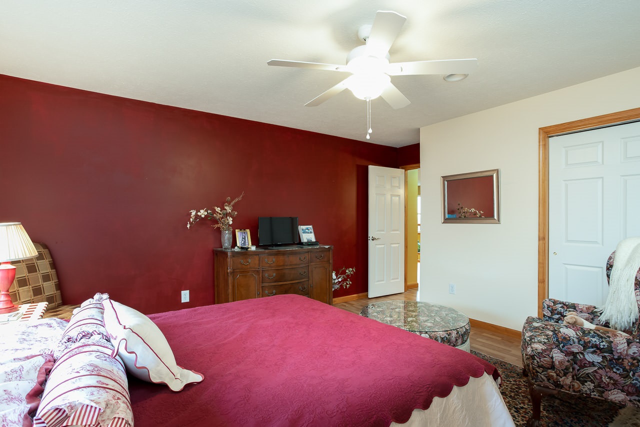 180 Ridgemore Drive Raphine, VA 24472 - Photo 37 of 68 a bedroom with a bed and a chandelier