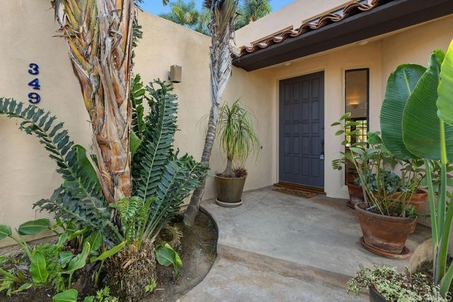 a view of a bedroom with wooden floor and stairs