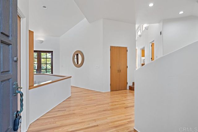 a dining hall with couches a flat tv screen and a coffee table