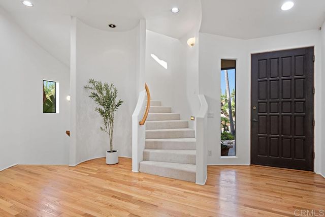 a kitchen with stainless steel appliances granite countertop sink stove and refrigerator