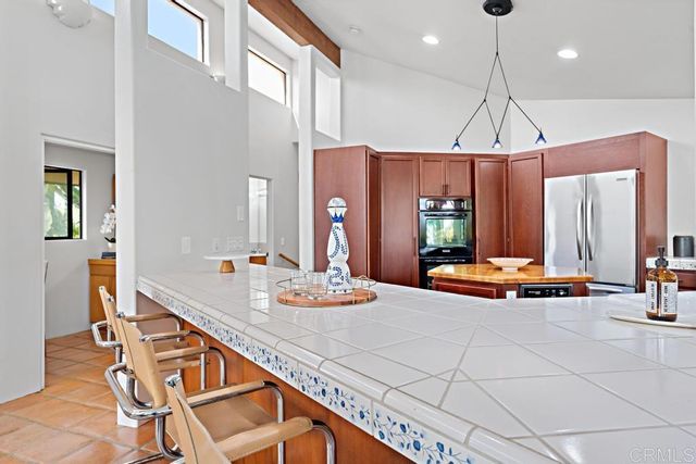 a living room with furniture fireplace and a large window