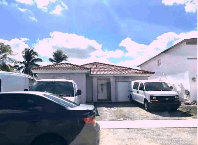 14260 Southwest 176th Terrace Miami, FL 33177 - Photo 1 of 1 a view of a white house with a yard