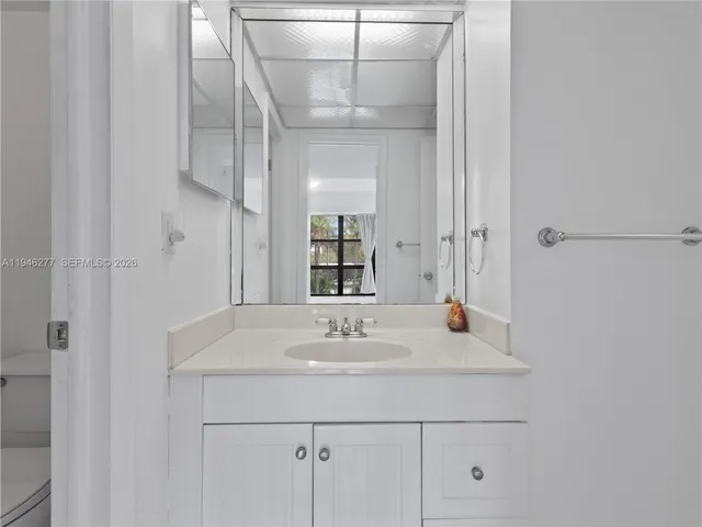 a bathroom with a granite countertop shower and a sink