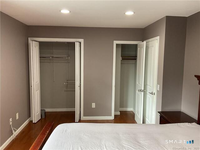 25 Padanaram Road, Unit 84 Danbury, CT 06811 - Photo 15 of 34 a bedroom with a bed and a large mirror