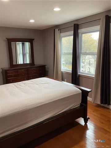 25 Padanaram Road, Unit 84 Danbury, CT 06811 - Photo 17 of 34 a bedroom with a large bed and a large window