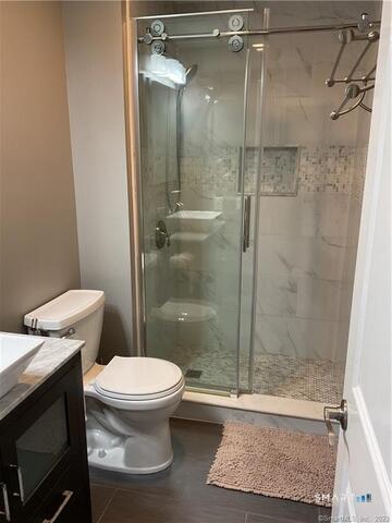 25 Padanaram Road, Unit 84 Danbury, CT 06811 - Photo 18 of 34 a bathroom with a toilet and a shower