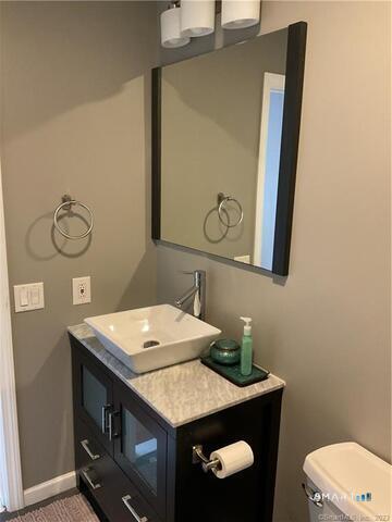 25 Padanaram Road, Unit 84 Danbury, CT 06811 - Photo 20 of 34 a bathroom with a sink vanity and toilet