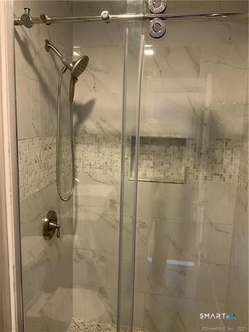 25 Padanaram Road, Unit 84 Danbury, CT 06811 - Photo 25 of 34 a bathroom with a glass shower door