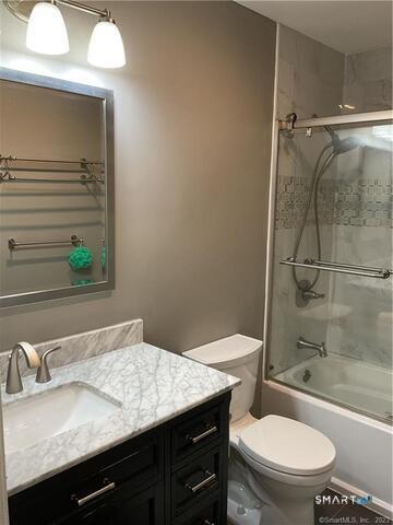 25 Padanaram Road, Unit 84 Danbury, CT 06811 - Photo 26 of 34 a bathroom with a granite countertop sink toilet a mirror and shower
