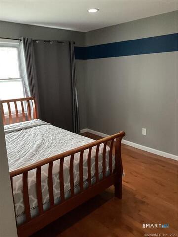 25 Padanaram Road, Unit 84 Danbury, CT 06811 - Photo 27 of 34 a bed sitting in a bedroom next to a window