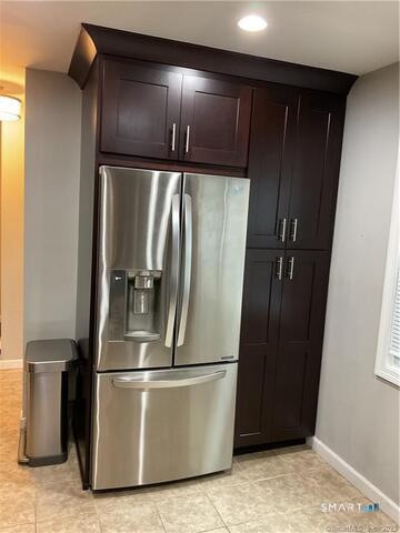 25 Padanaram Road, Unit 84 Danbury, CT 06811 - Photo 4 of 34 a metallic refrigerator freezer sitting in a room