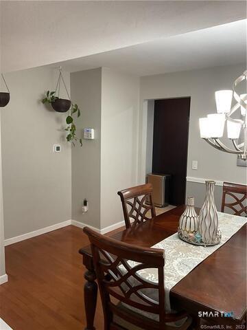 25 Padanaram Road, Unit 84 Danbury, CT 06811 - Photo 7 of 34 a view of a dining room with furniture and wooden floor