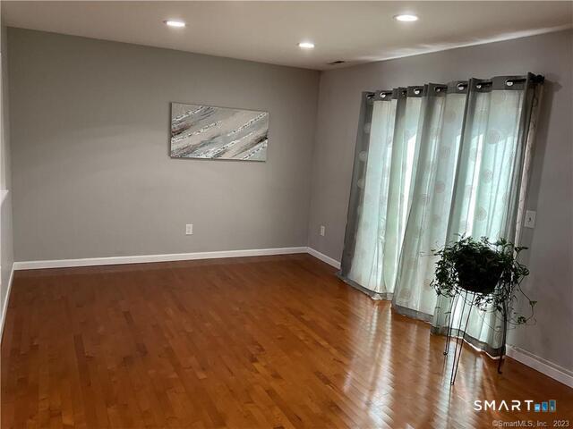 25 Padanaram Road, Unit 84 Danbury, CT 06811 - Photo 8 of 34 a view of a room with wooden floor and a potted plant