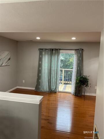 25 Padanaram Road, Unit 84 Danbury, CT 06811 - Photo 10 of 34 a view of an empty room with wooden floor and a window