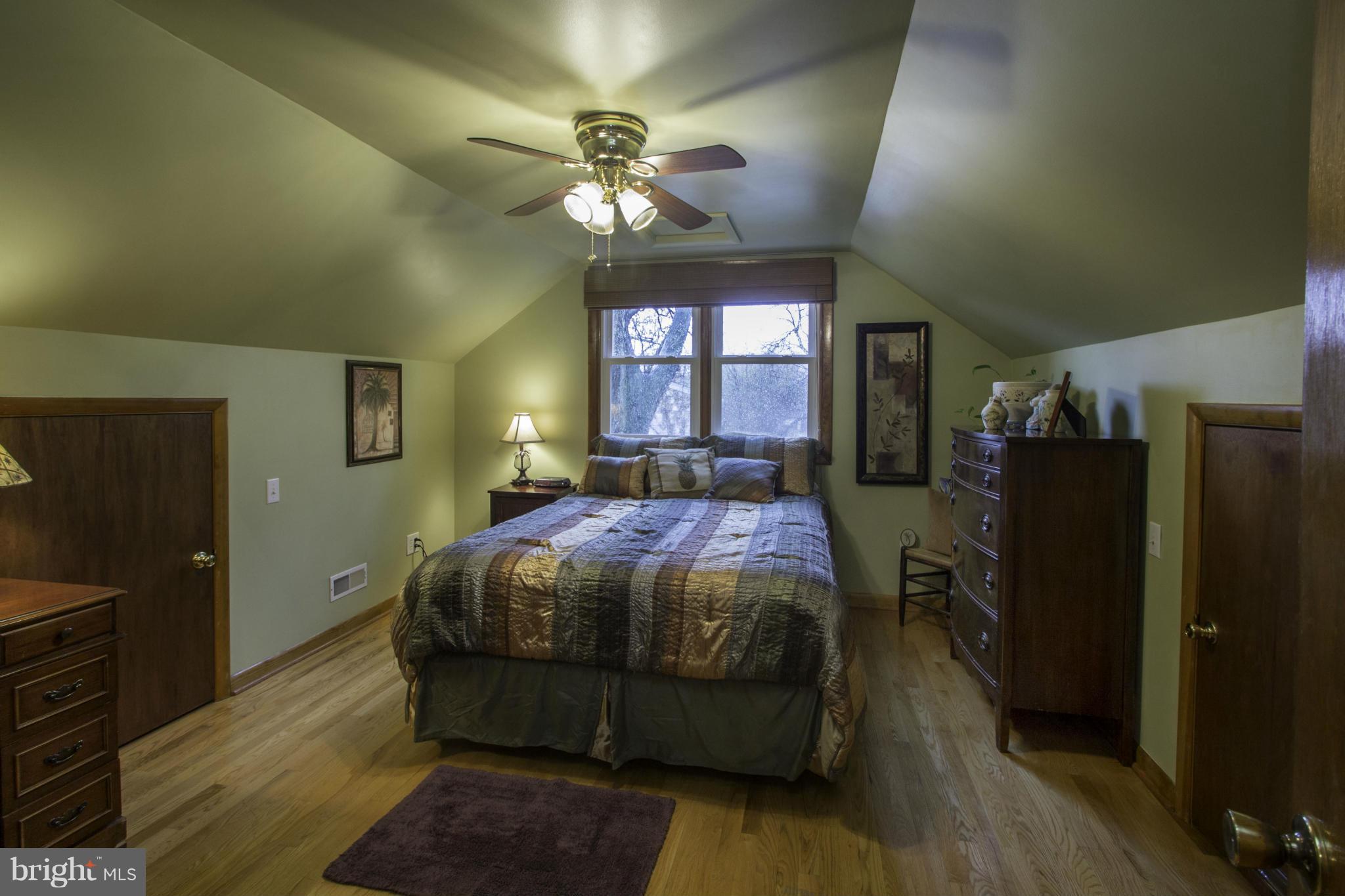 210 North Hammonds Ferry Road Linthicum, MD 21090 - Photo 14 of 30 a spacious bedroom with a bed and a chandelier