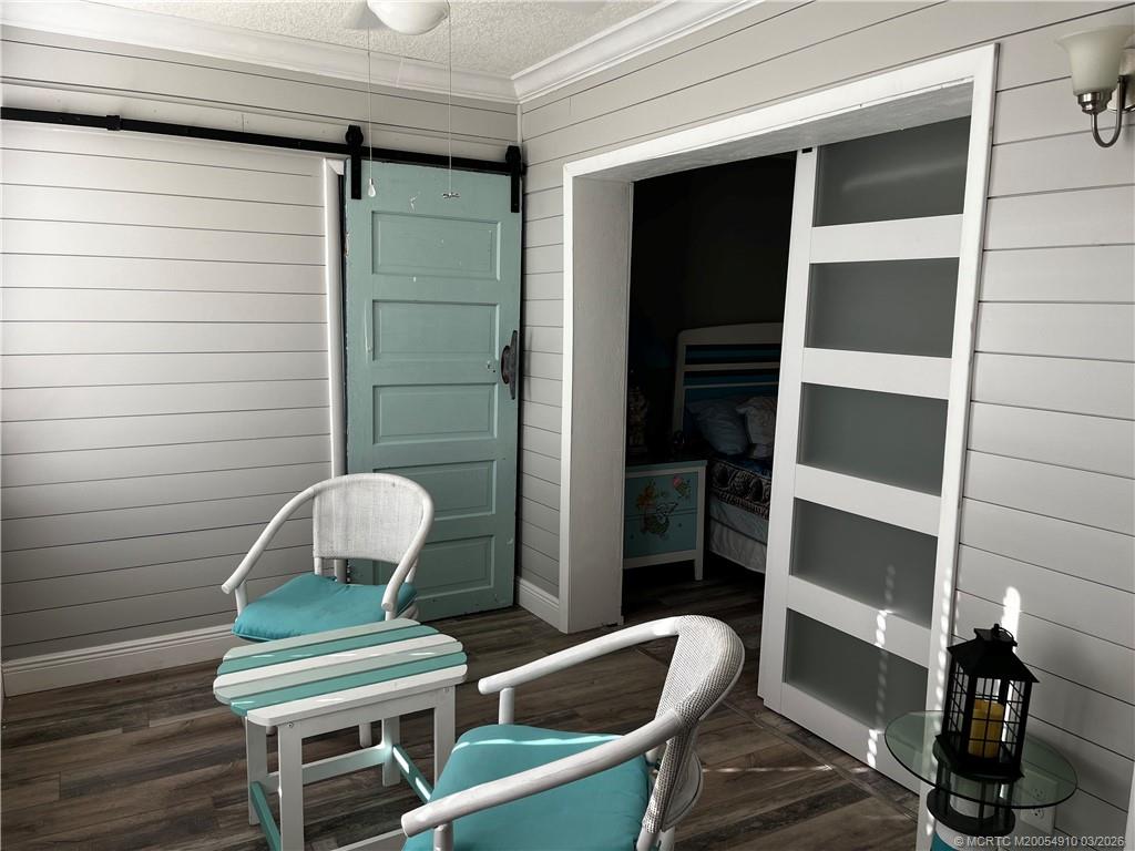 5323 Southeast Miles Grant Road, Unit 206 Stuart, FL 34997 - Photo 12 of 20 a chair and table in a room