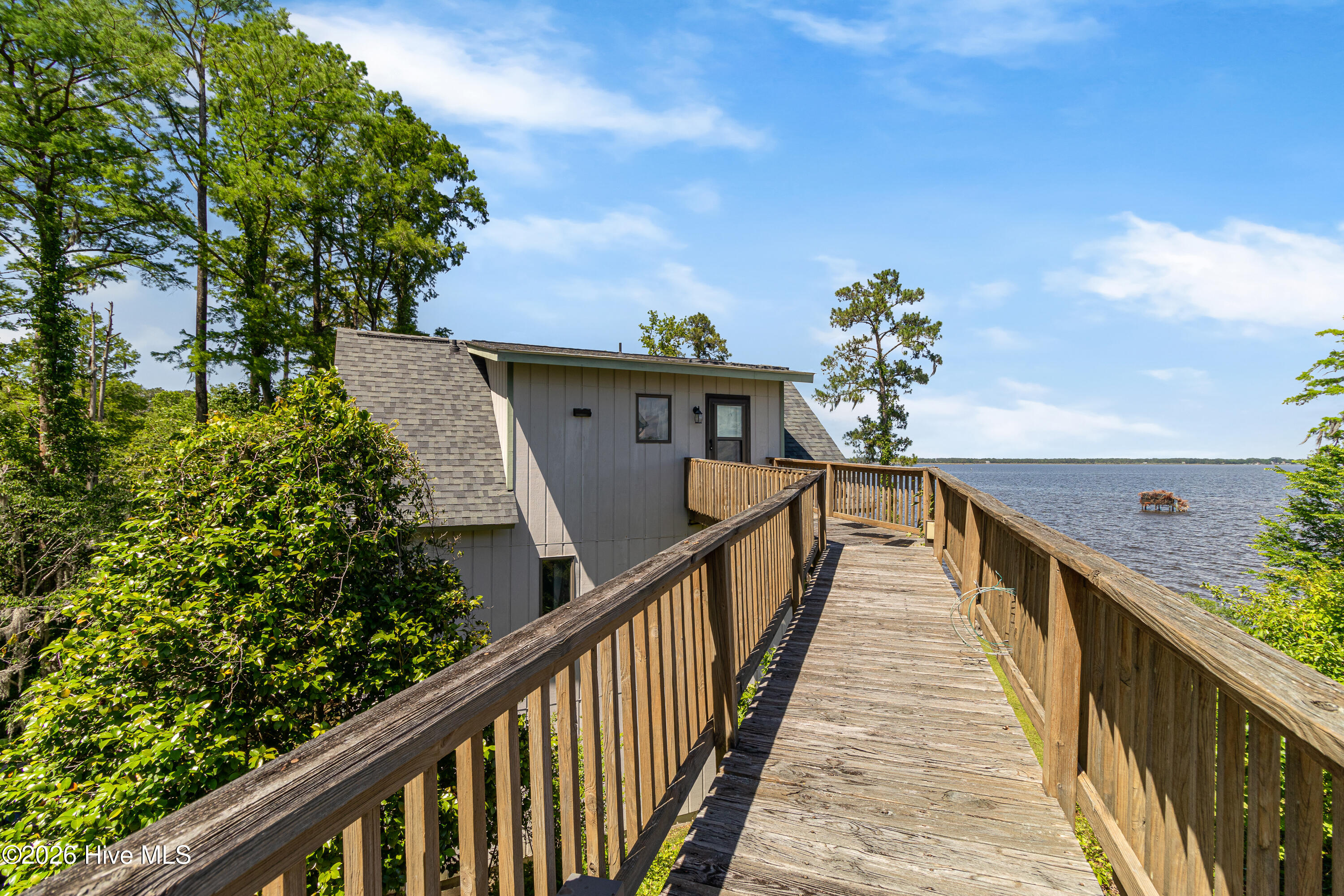 4100 North Rivershore Drive New Bern, NC 28560 - Photo 46 of 87 A distinctive elevated walkway connects the main residence to a private guest retreat, creating a one-of-a-kind waterfront compound feel with panoramic lake views from nearly every angle.