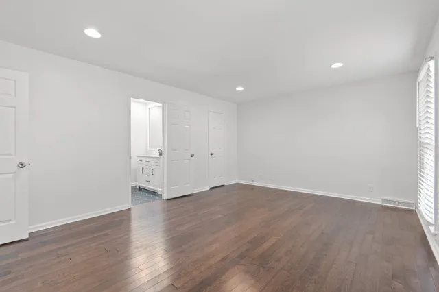 an empty room with wooden floor