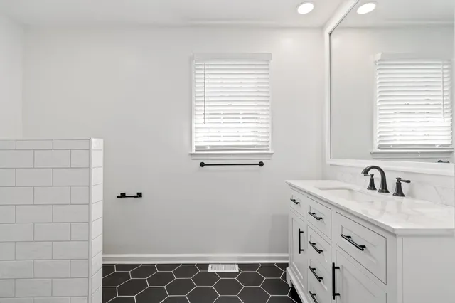 a bathroom with a sink and a mirror