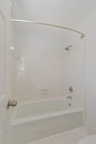 a bathroom with a shower and a bath tub