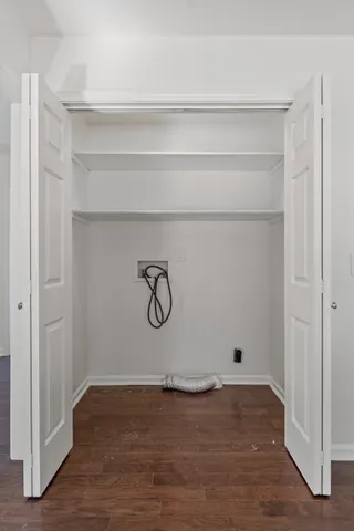 a view of a room with an empty space and wooden floor