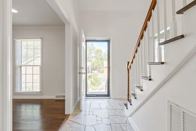 a view of an entryway with wooden floor and door