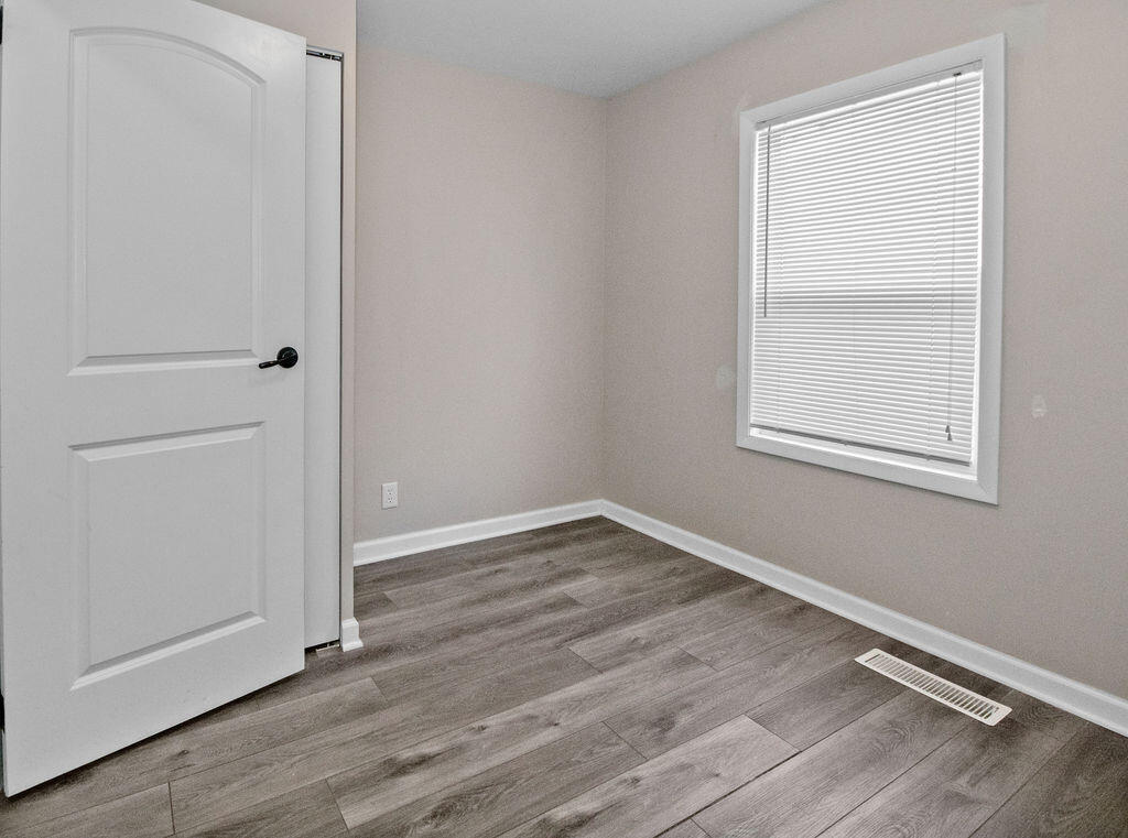 309 Michigami Trail Porter, IN 46304 - Photo 16 of 21 a view of an empty room with wooden floor and a window