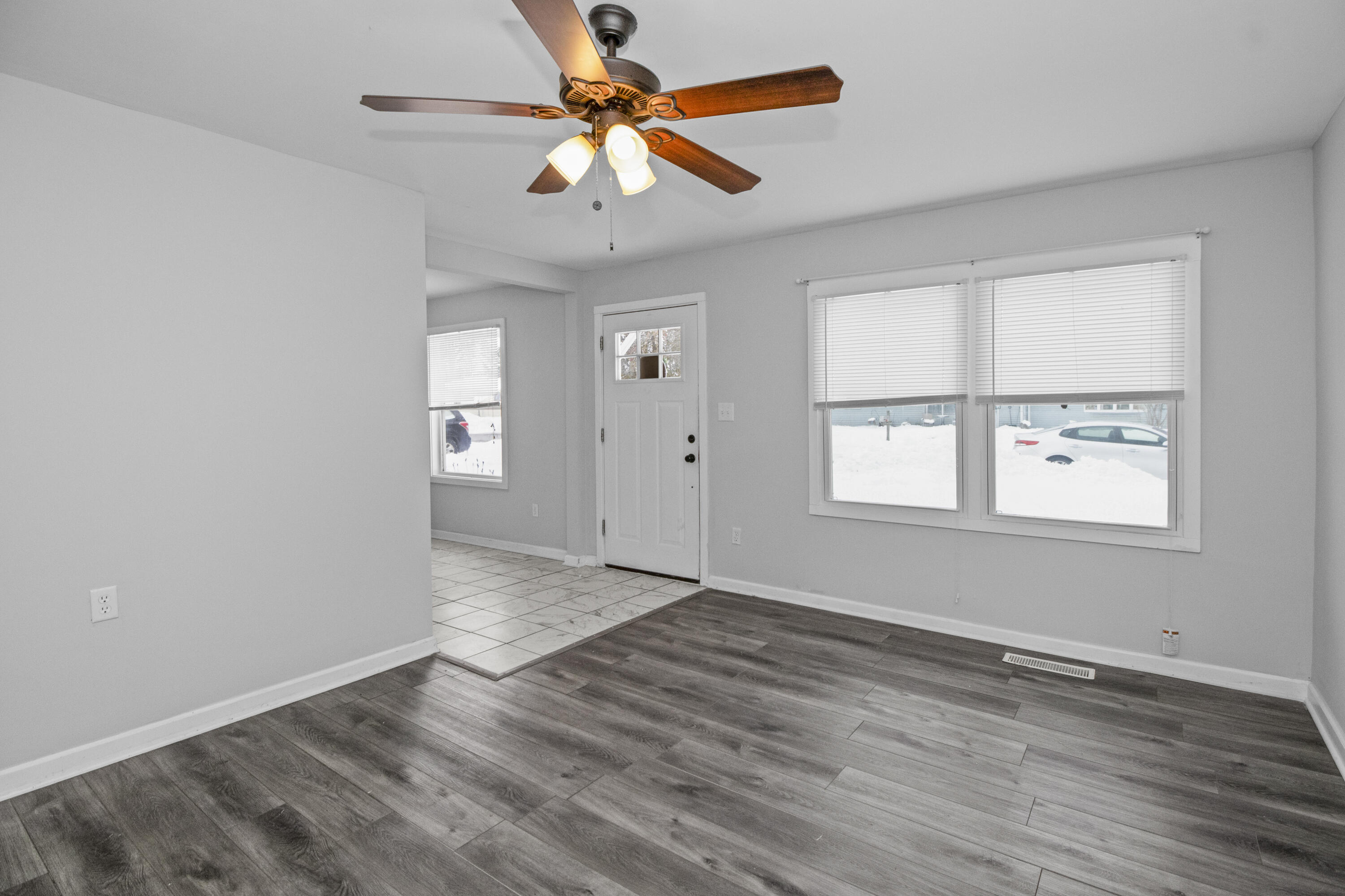 309 Michigami Trail Porter, IN 46304 - Photo 3 of 21 an empty room with wooden floor fan and windows