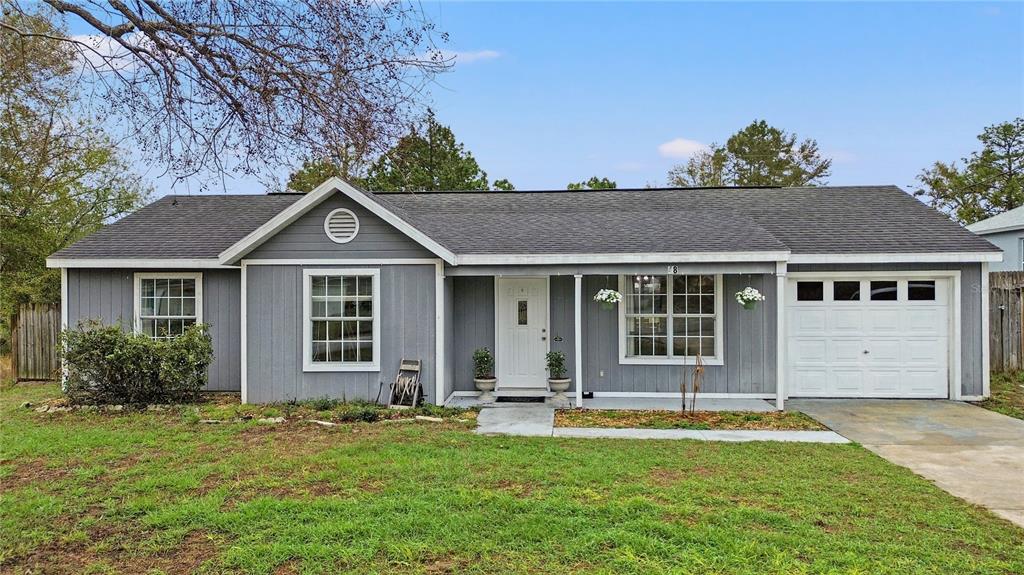 48 Pine Trace Loop Ocala, FL 34472 - Photo 1 of 1 a front view of a house with a yard