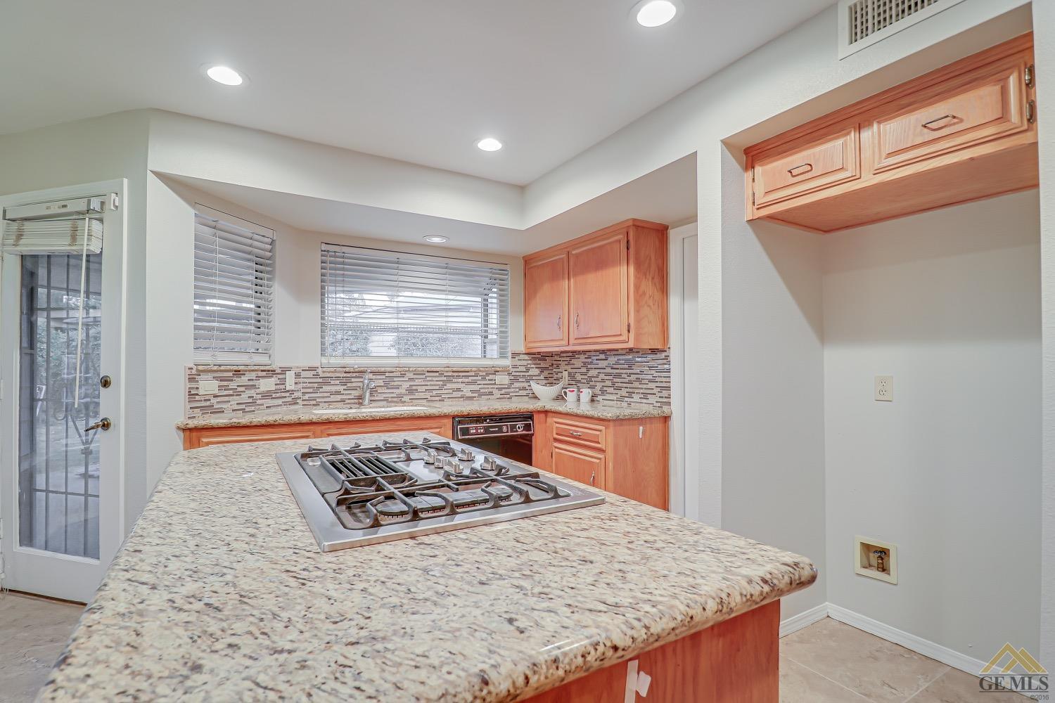 Undisclosed Address Bakersfield, CA 93314 - Photo 12 of 38 a kitchen with stainless steel appliances granite countertop a stove a sink and a refrigerator