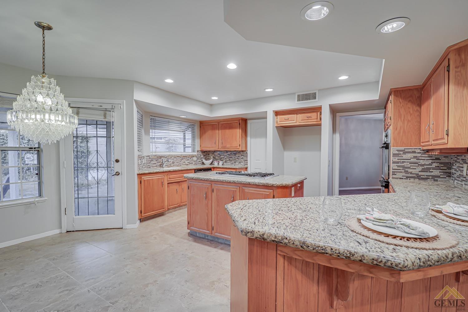 Undisclosed Address Bakersfield, CA 93314 - Photo 15 of 38 a kitchen with stainless steel appliances granite countertop a sink and a refrigerator