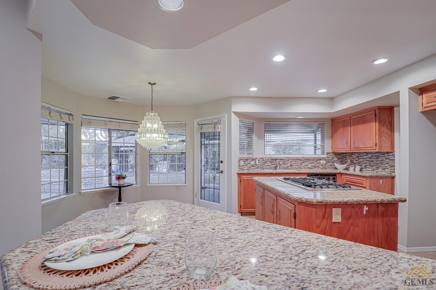 Undisclosed Address Bakersfield, CA 93314 - Photo 16 of 38 a kitchen with stainless steel appliances granite countertop a stove and a refrigerator
