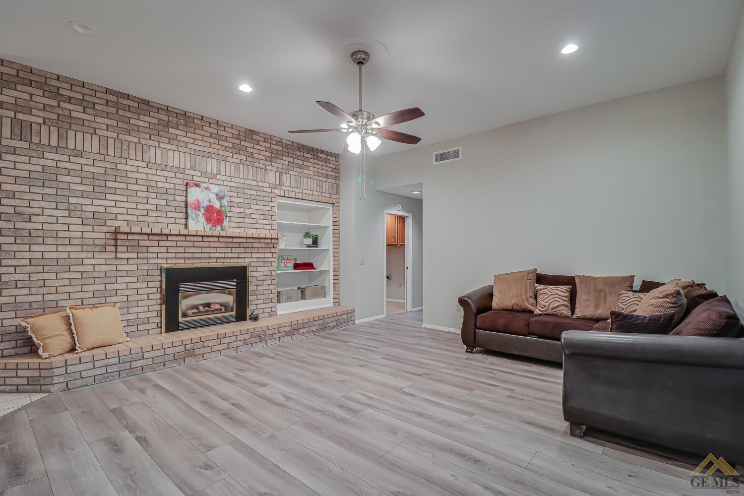 Undisclosed Address Bakersfield, CA 93314 - Photo 19 of 38 a living room with furniture and a fireplace