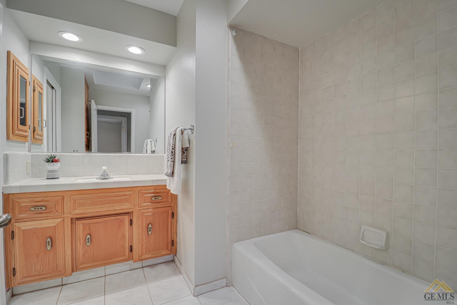 Undisclosed Address Bakersfield, CA 93314 - Photo 24 of 38 a bathroom with a granite countertop sink a toilet and a mirror